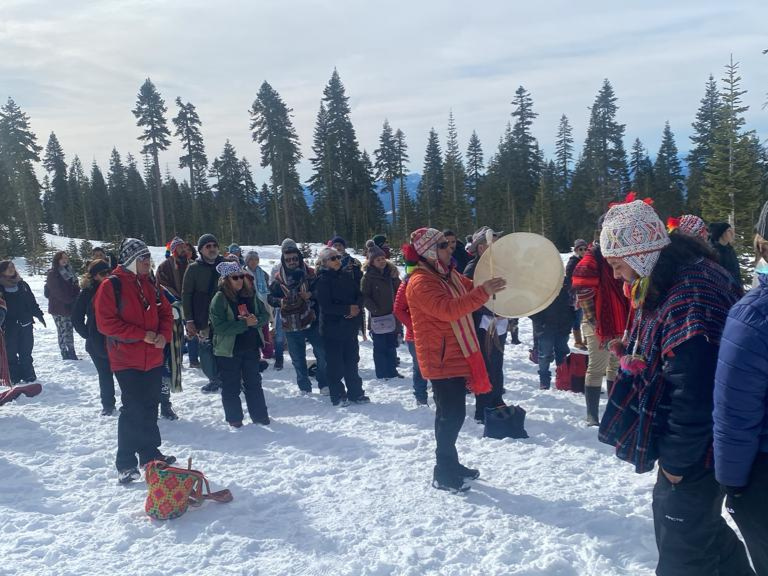 "Andean shamans and participants gathered in the snow during a traditional ceremony, connecting with nature and ancestral wisdom."
